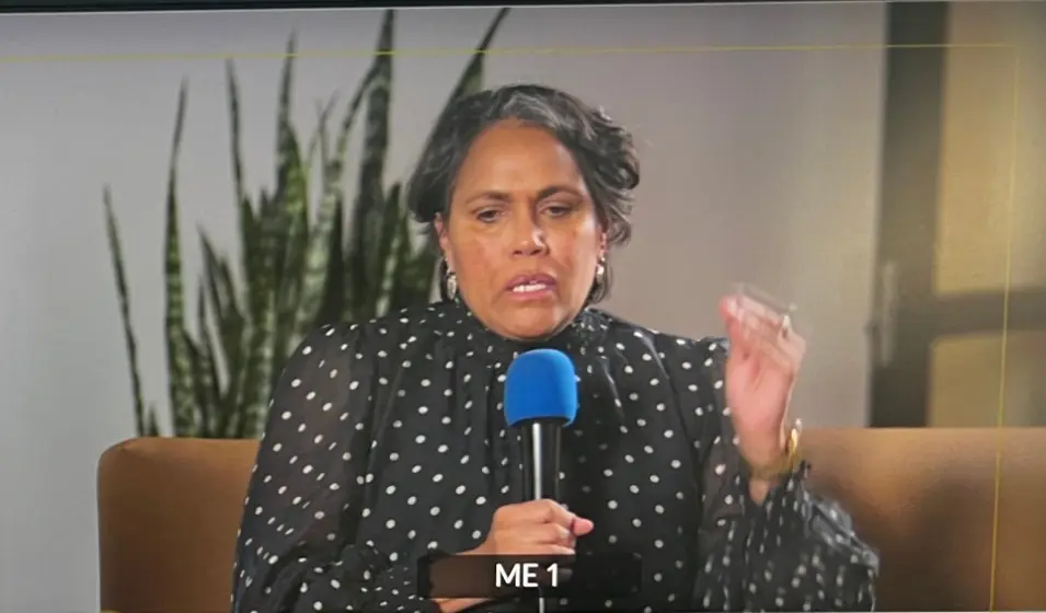 A close-up camera shot on the programme monitor of a panellist speaking into a microphone during a NAIDOC Week panel